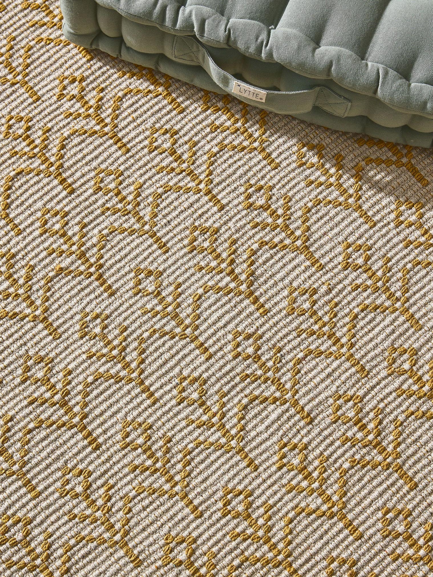 Teppich aus 60% Baumwolle (recycelt), 40 % Polyester in Gelb mit 6 bis 10 mm hohem Flor von Lytte